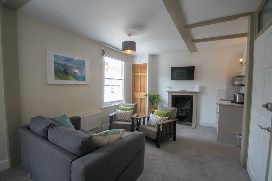Living room area in one bedroom holiday family suite